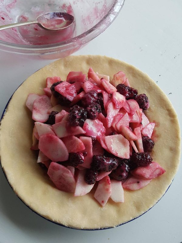 Spoon filling into pie plate