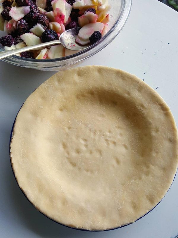 Line pie plate with pastry