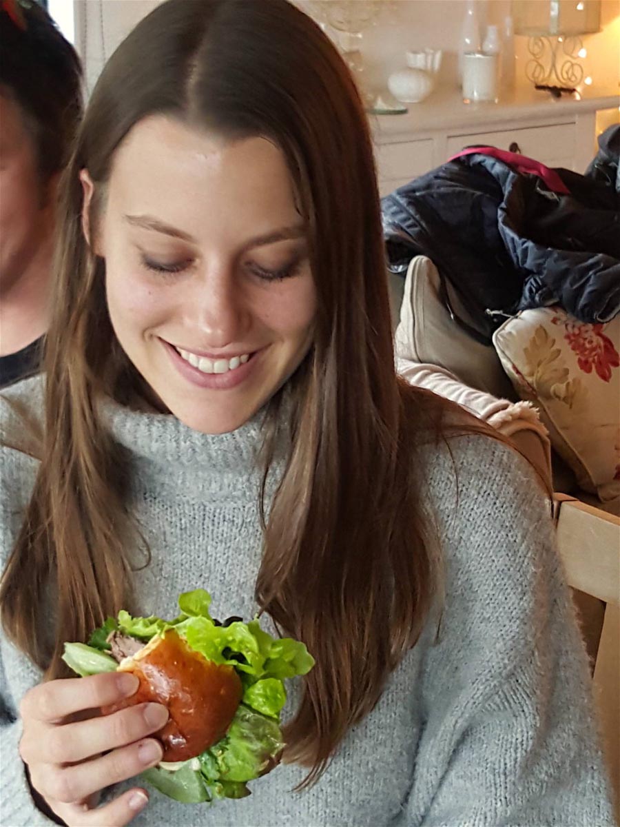 Ilaria munches a brioche salad roll