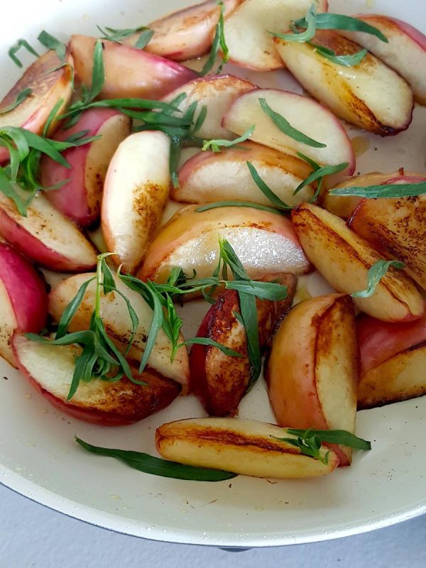 White peaches in the pan with tarragon